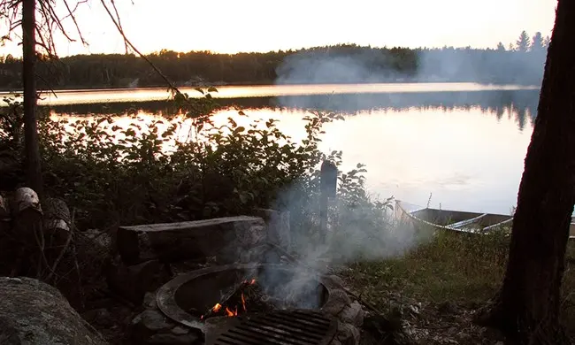 National Park Service — canoe beside the water at Peary Lake | Voyageurs Backcountry by Canoe: The Two-Stage Journey to a Remote Lake
