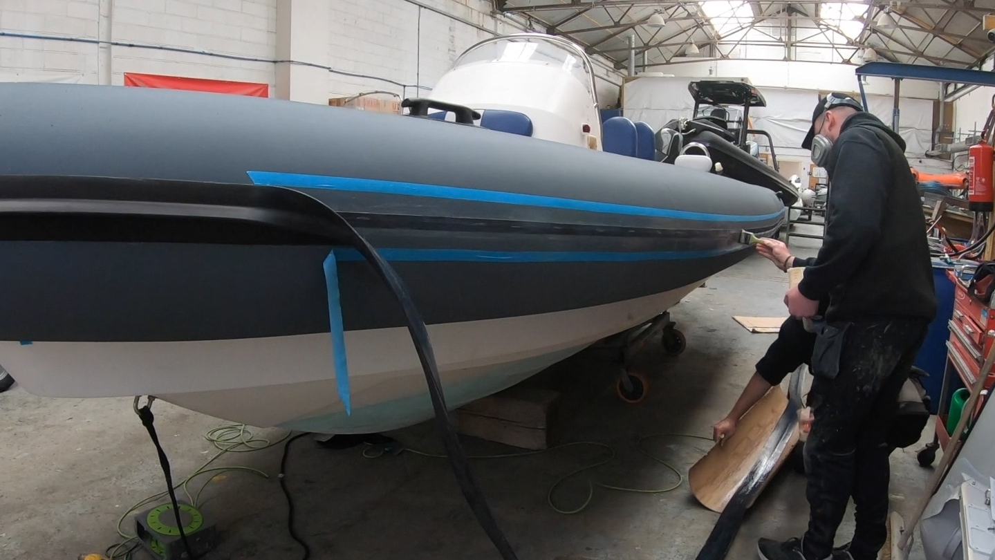 MDL Marinas — official photograph of a RIB in the tube-replacement workshop