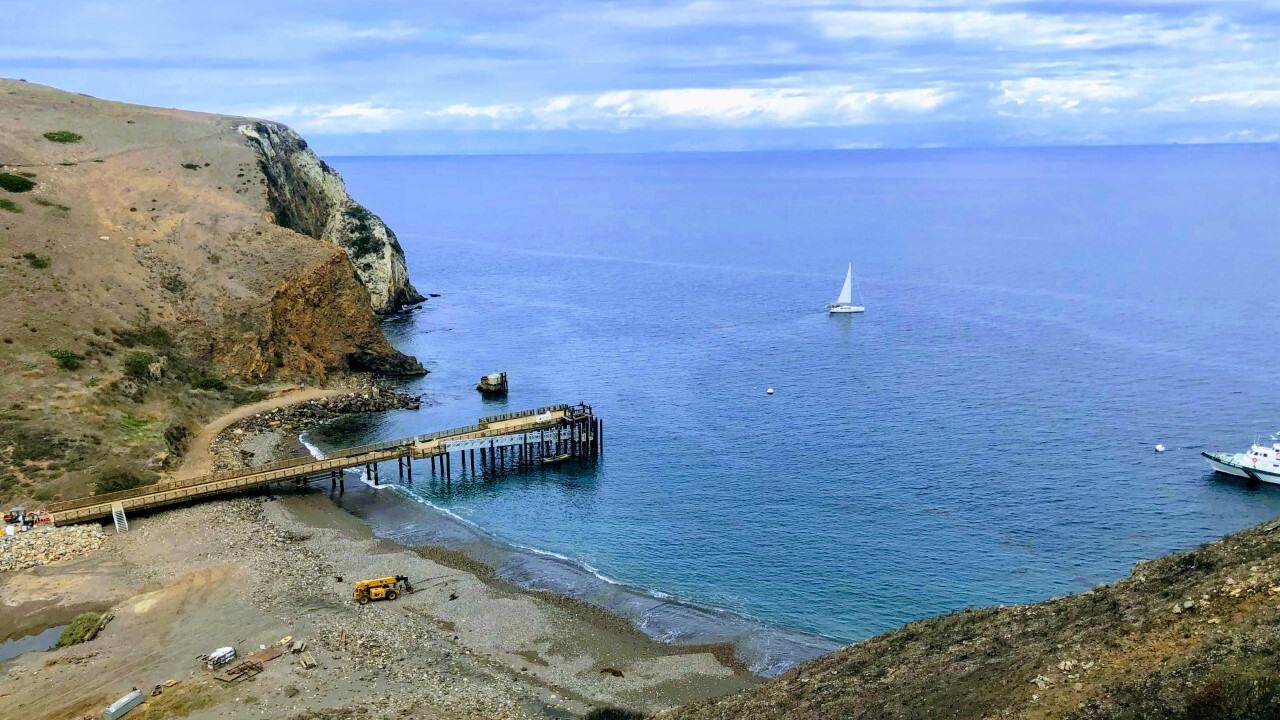 National Park Service — Scorpion Anchorage and pier, Santa Cruz Island, seen from the southeast hilltop. NPS Gallery asset c7c240ad-14c7-405d-8a88-fd16c8143e13; NPS Photo; Public domain Full Granting Rights.
