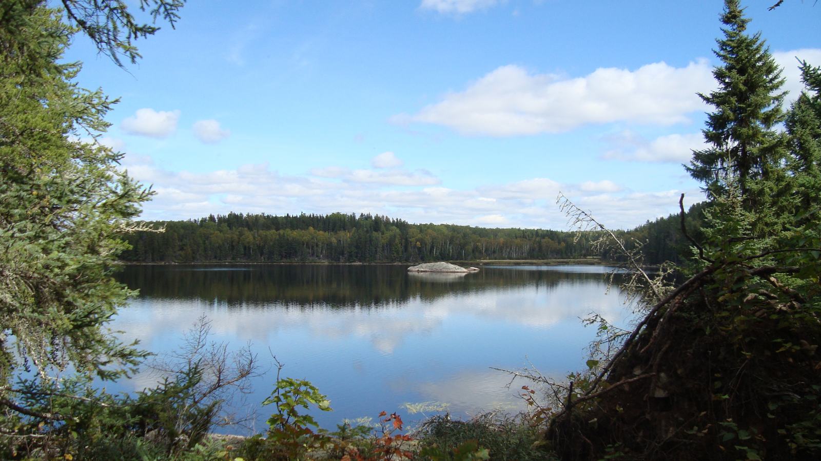 U.S. National Park Service, public-domain photograph: island campsite and quiet shoreline at Voyageurs National Park.