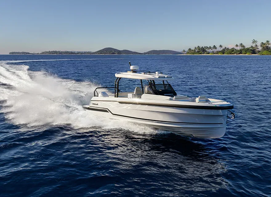 Wellcraft 33 T-Top motorboat cruising at sea.